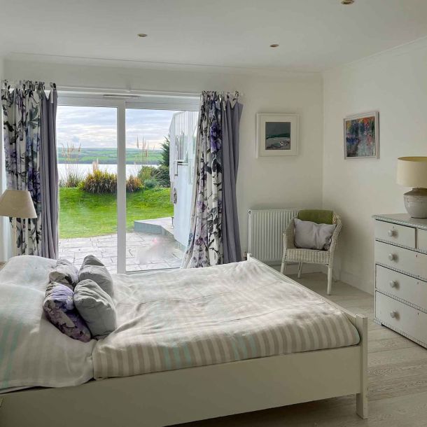 Tomhara bedroom with king-size bed and view over the estuary